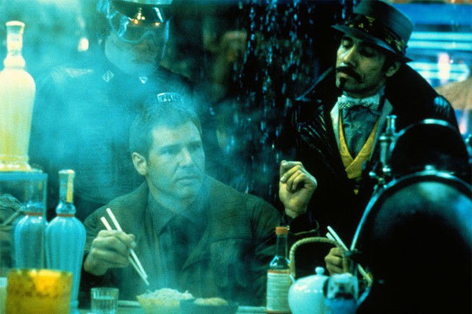cena em tons de azul de blade runner em que deckard come macarrão na rua e oficiais chegam para intimá-lo