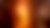 Silhueta de um menino, diante de uma enorme luz laranja.