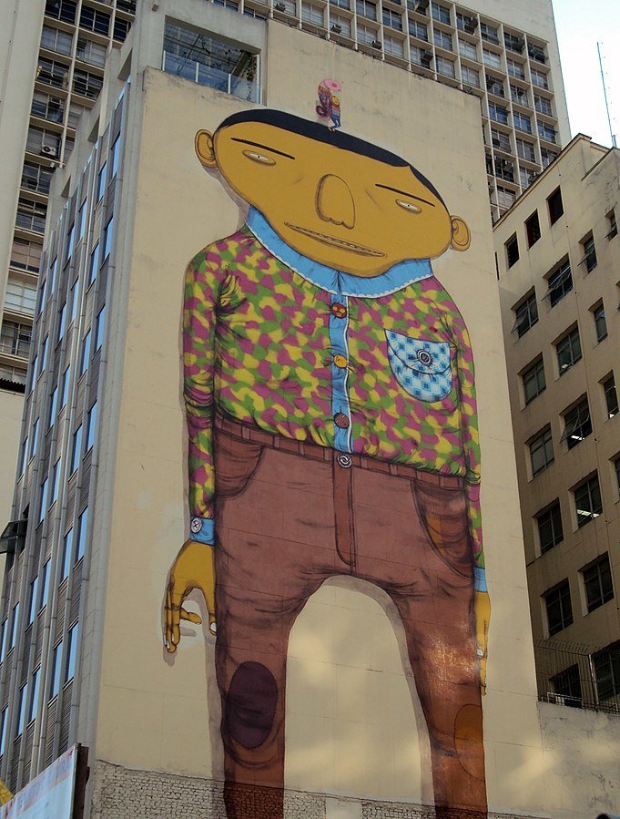grafite dos Gemeos representando um menino amarelo em prédio